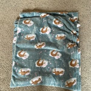 A pink label sloth blanket